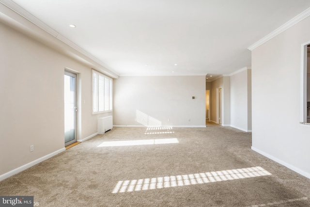 spare room with light carpet, radiator, and crown molding