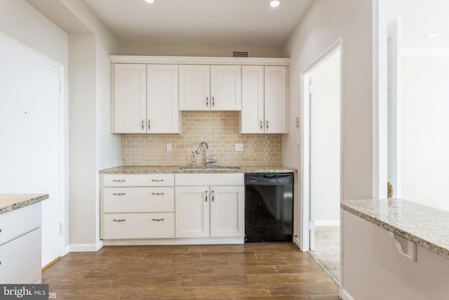 kitchen featuring black dishwasher, sink, white cabinets, and decorative backsplash