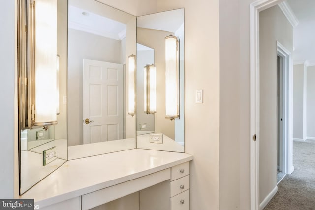 bathroom featuring crown molding and vanity