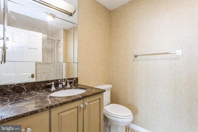 bathroom with vanity, an enclosed shower, and toilet