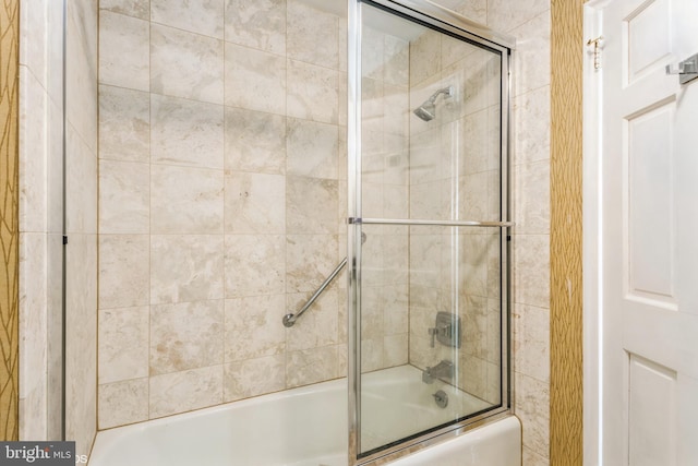 bathroom with shower / bath combination with glass door