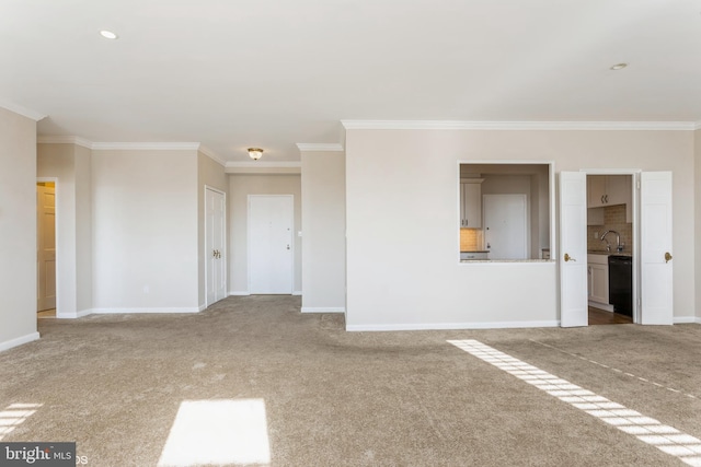 carpeted spare room featuring ornamental molding and sink