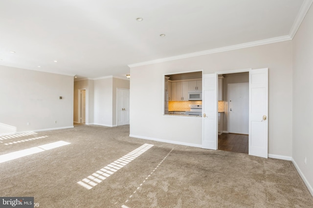 unfurnished living room with ornamental molding and carpet