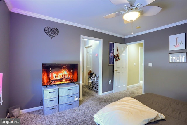 carpeted bedroom with ornamental molding and ceiling fan