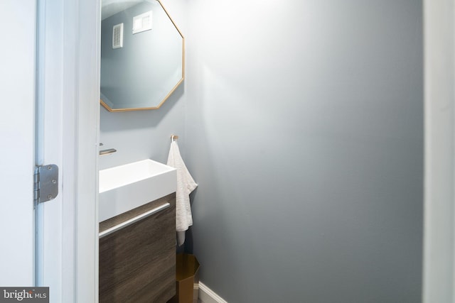 bathroom with visible vents and a sink