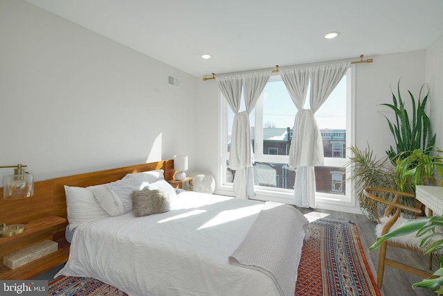 bedroom with visible vents, recessed lighting, and wood finished floors