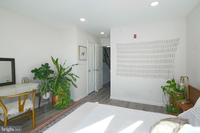 bedroom with recessed lighting, wood finished floors, and baseboards