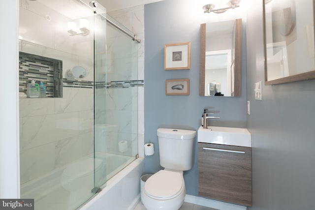 full bathroom with vanity, toilet, and bath / shower combo with glass door