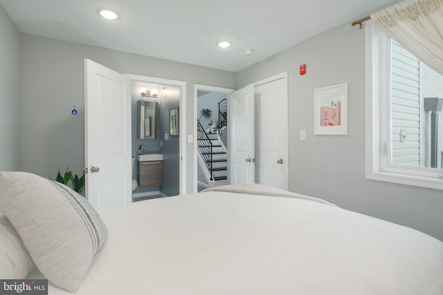 bedroom featuring a sink, connected bathroom, and recessed lighting