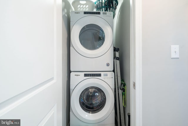 washroom with laundry area and stacked washer / dryer