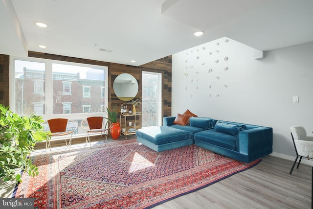 living room featuring visible vents, recessed lighting, wood finished floors, and baseboards