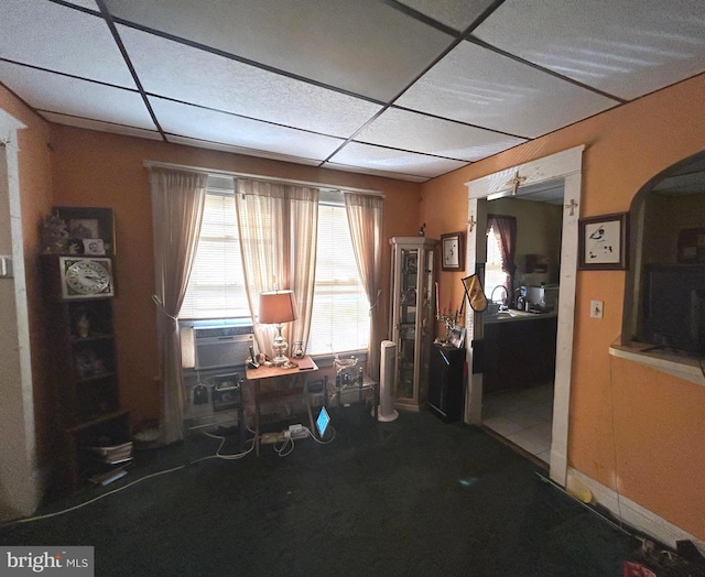 miscellaneous room featuring arched walkways, carpet, cooling unit, and a paneled ceiling