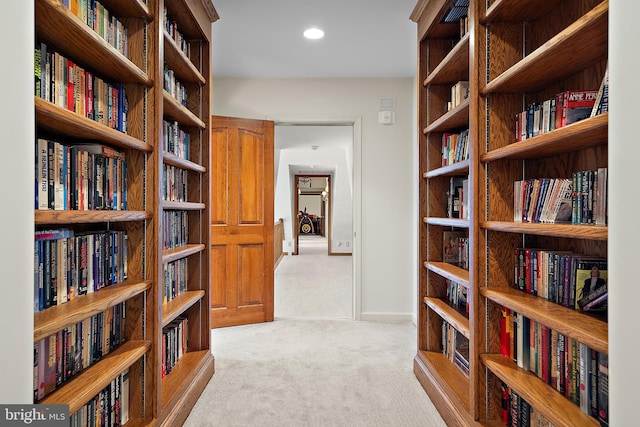 hall featuring light colored carpet