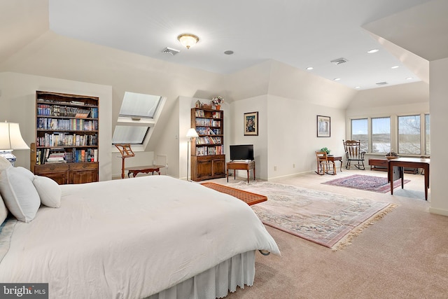 carpeted bedroom with vaulted ceiling with skylight