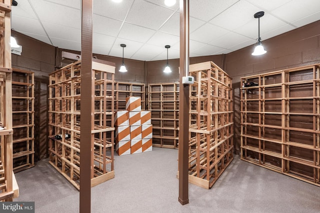 wine room featuring a drop ceiling and carpet flooring