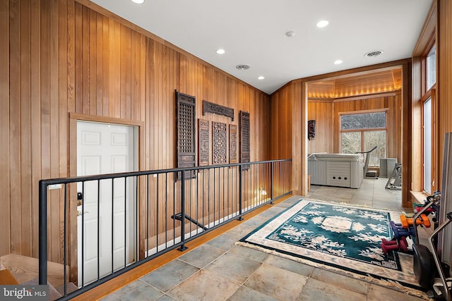 hallway with wood walls