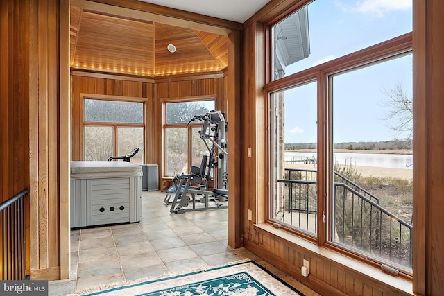 entryway featuring wood walls and a water view