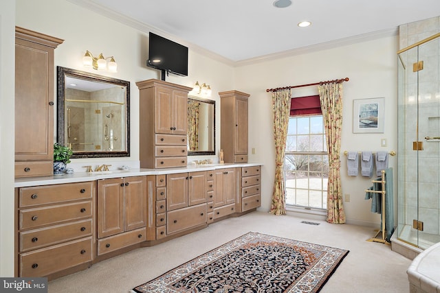 bathroom with crown molding, vanity, and a shower with shower door