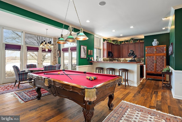 rec room featuring crown molding, a healthy amount of sunlight, dark hardwood / wood-style floors, and french doors