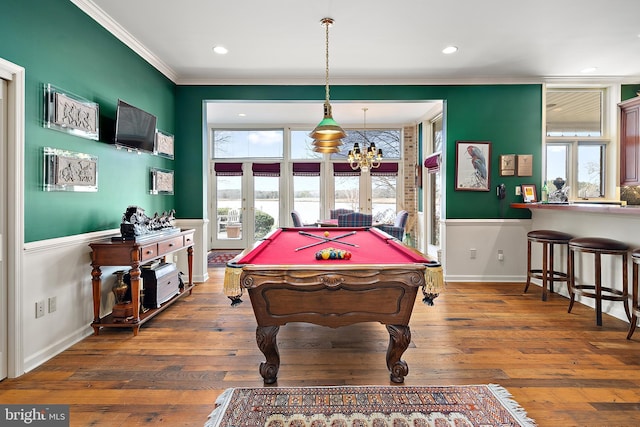 game room featuring french doors, pool table, ornamental molding, and dark hardwood / wood-style floors