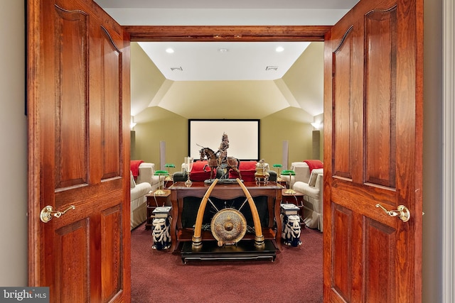 home theater featuring lofted ceiling and carpet flooring