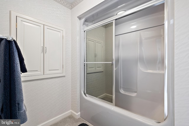 bathroom featuring combined bath / shower with glass door