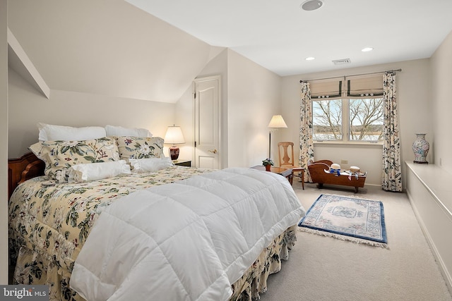 carpeted bedroom featuring lofted ceiling