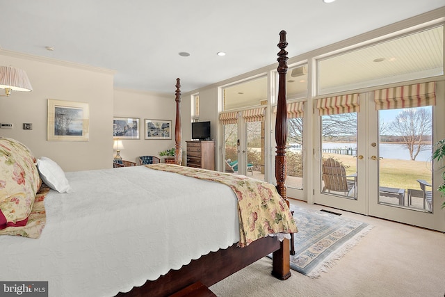 carpeted bedroom with french doors, crown molding, multiple windows, and access to outside