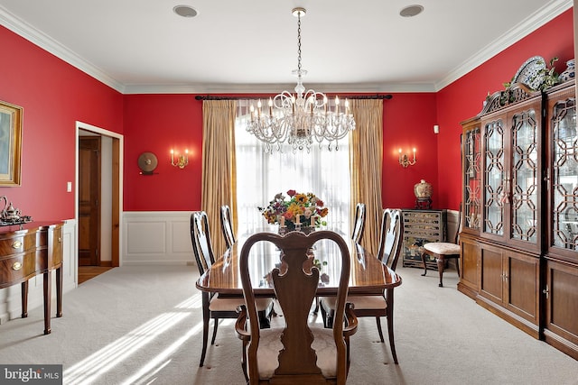 dining space featuring light carpet, crown molding, and a chandelier