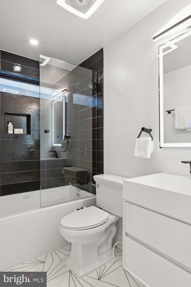 full bathroom featuring vanity, toilet, and tiled shower / bath