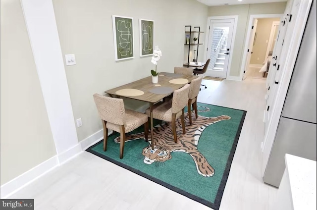 dining area featuring a barn door and hardwood / wood-style floors