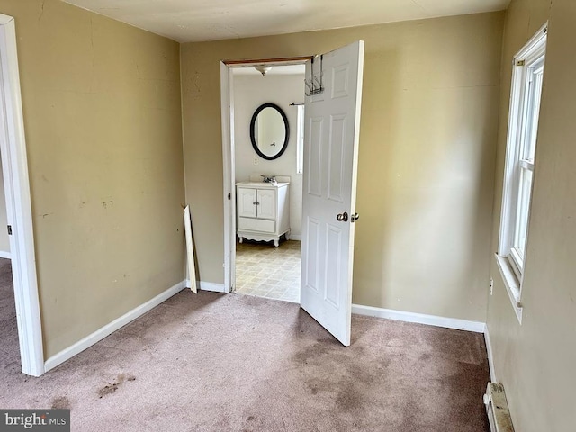 unfurnished bedroom with carpet flooring and sink