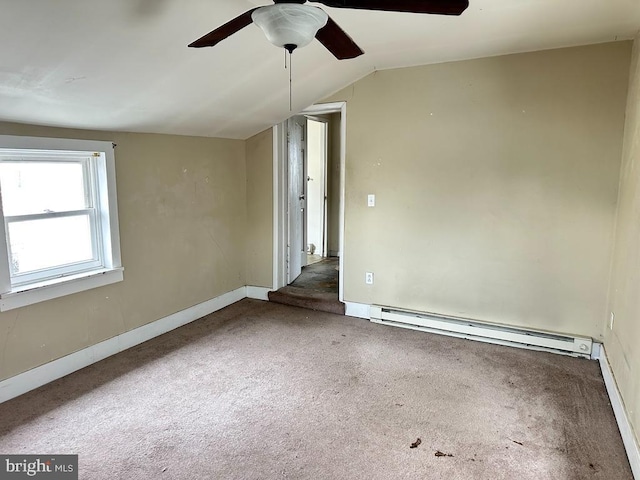 spare room with lofted ceiling, dark carpet, a baseboard radiator, and ceiling fan