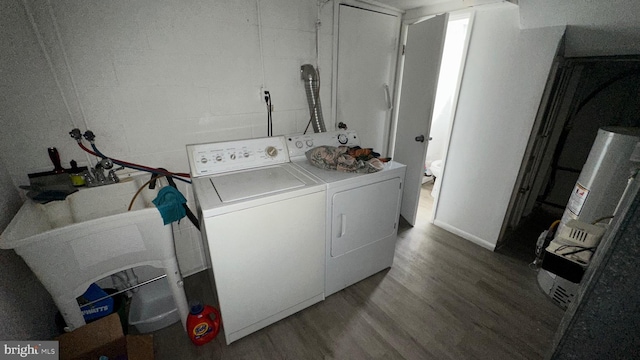 washroom with washing machine and dryer and hardwood / wood-style floors