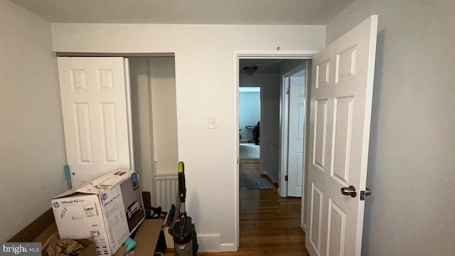 corridor featuring dark hardwood / wood-style flooring