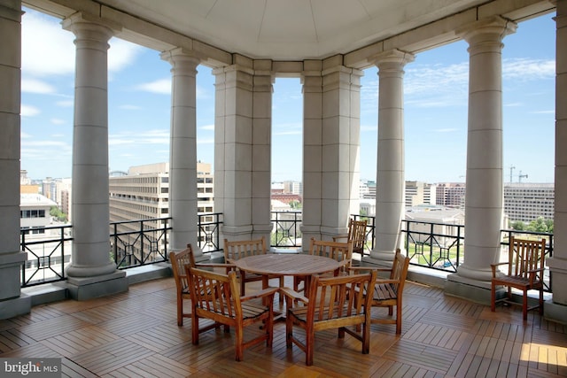 interior space with expansive windows, decorative columns, and a wealth of natural light