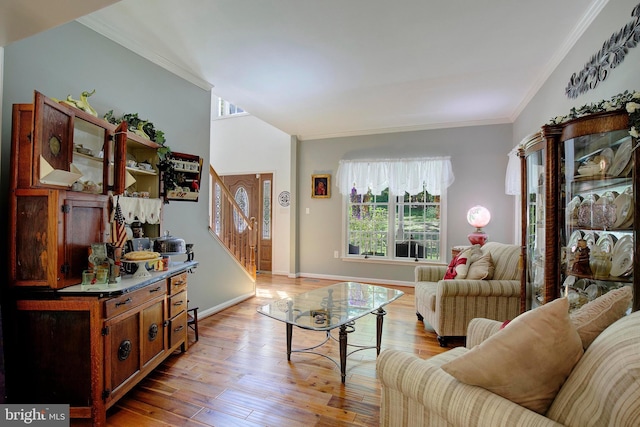 living room featuring ornamental molding and light hardwood / wood-style floors