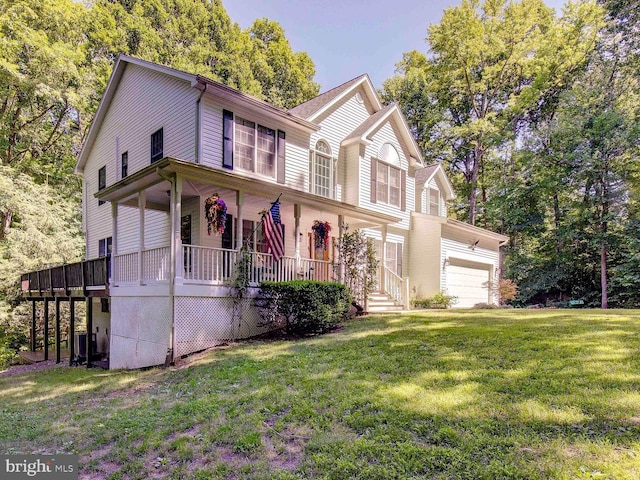 view of front facade featuring central AC unit, a garage, a front lawn, and a porch