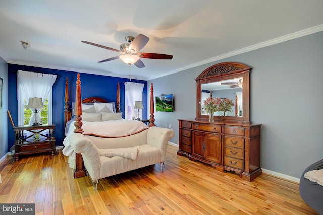 bedroom featuring light hardwood / wood-style flooring, ornamental molding, and ceiling fan