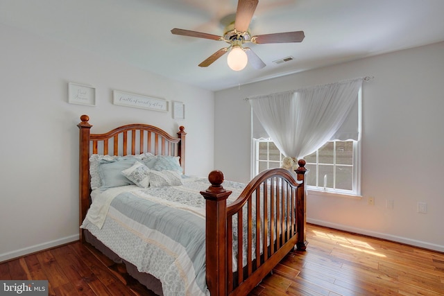 bedroom with hardwood / wood-style flooring and ceiling fan