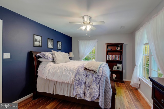 bedroom with wood-type flooring and ceiling fan