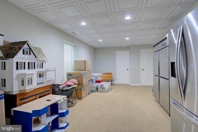 recreation room with light colored carpet