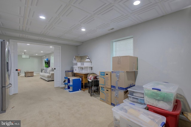 interior space with stainless steel refrigerator with ice dispenser and light carpet