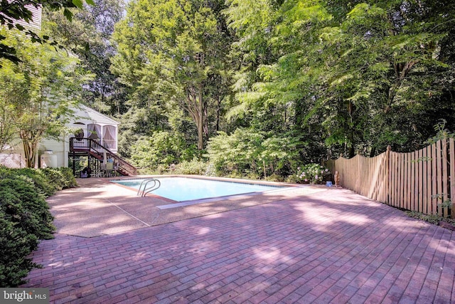 view of swimming pool with a patio and a deck