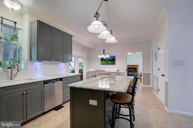 kitchen featuring sink, gray cabinetry, a center island, stainless steel dishwasher, and pendant lighting