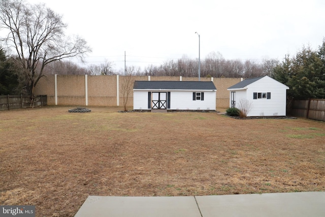 exterior space with a storage unit and a fire pit