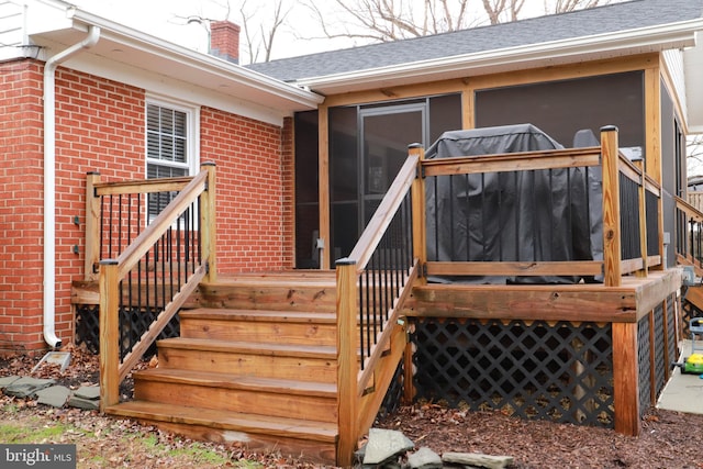 exterior space featuring a wooden deck and a sunroom