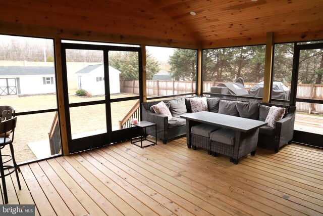 sunroom featuring lofted ceiling and wooden ceiling