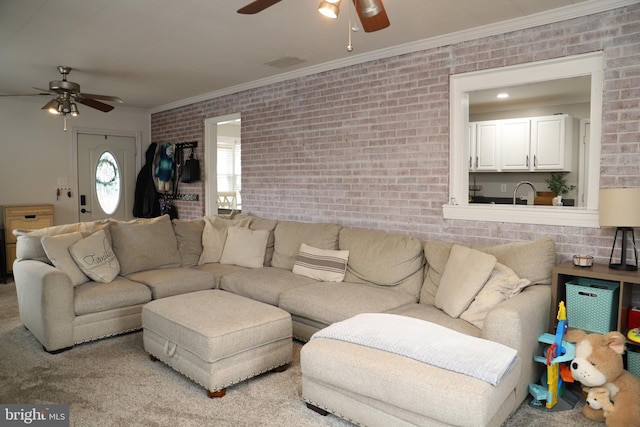 living room featuring ornamental molding, brick wall, and ceiling fan