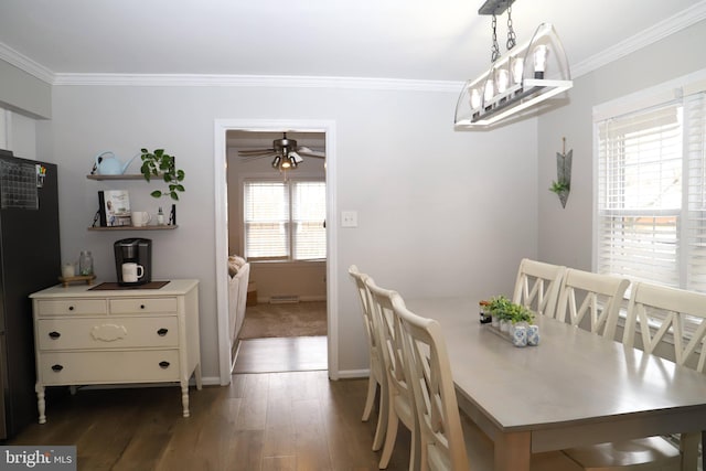 dining area featuring crown molding, dark hardwood / wood-style floors, and ceiling fan